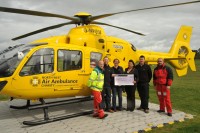 Bent and Bongs Charitable Trust committee members present a cheque for £5000 to the North West Air Ambulance