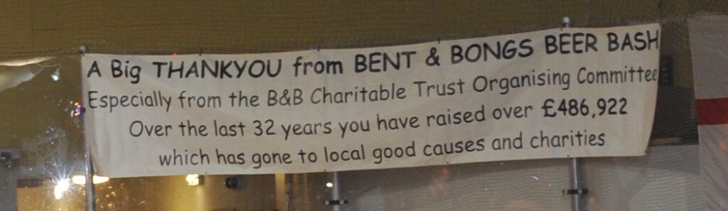 A banner at the 2023 festival shows the total raised by the event; £486,922